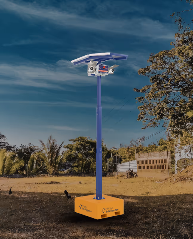 Outdoor surveillance pole with solar panel, two security cameras, and Vision Intelligence branding at the base.