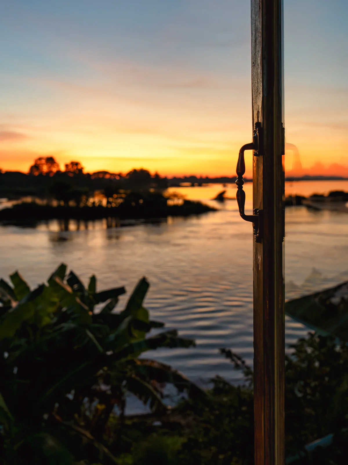 Sunset over the Mekong River seen from a riverside deck in Laos
