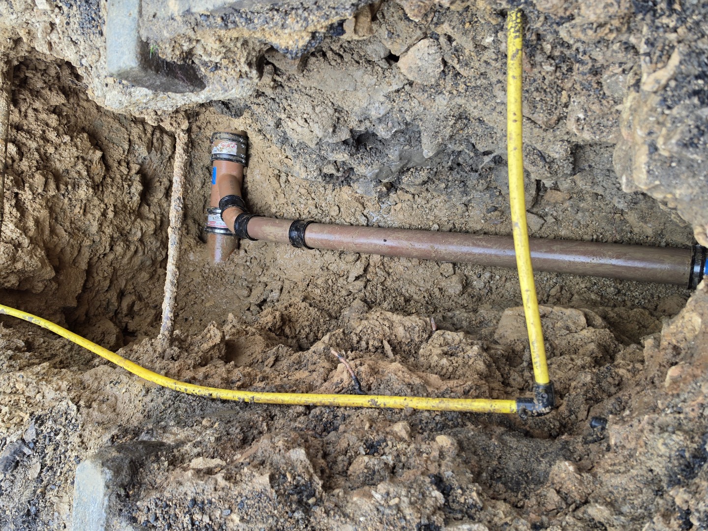 Close-up of repaired pipework joints in the excavation