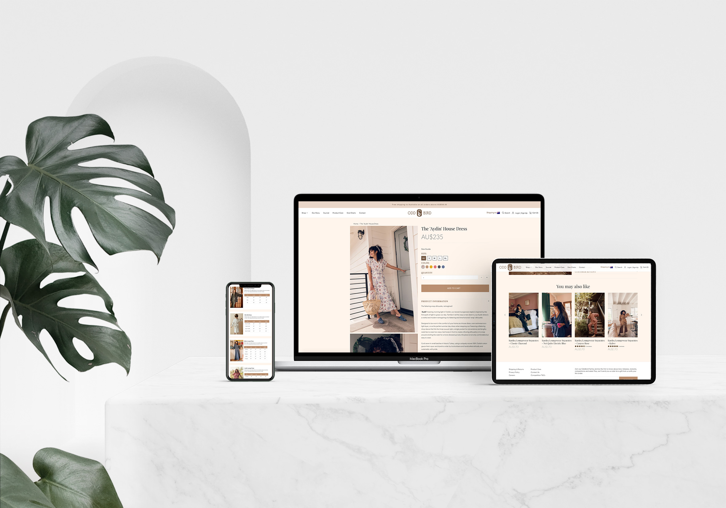 The Oddbird Co. website shown on a laptop, tablet and phone beside a monstera plant