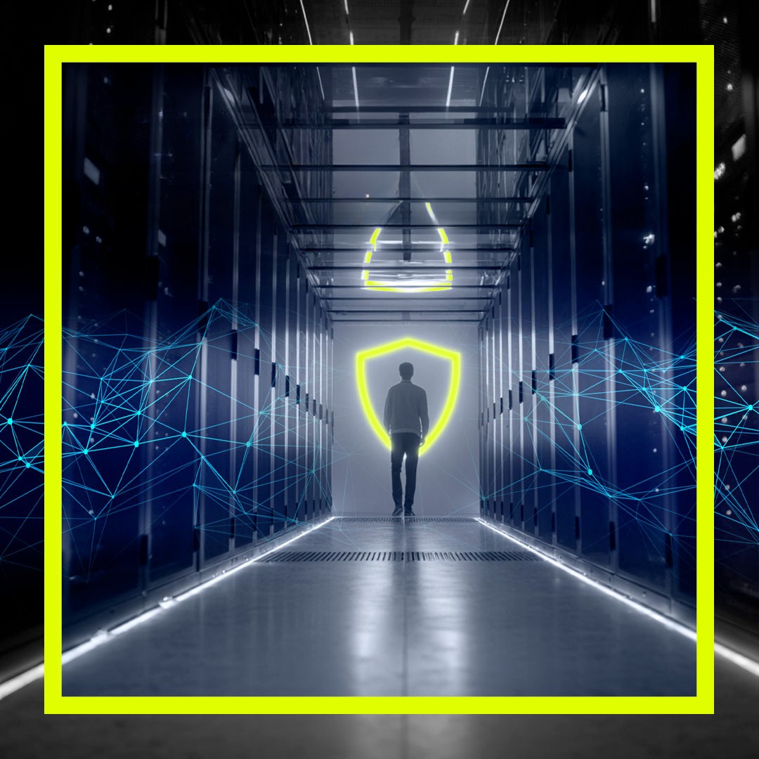 Man standing in server room with a neon image of a secure icon indicating secure connectivity
