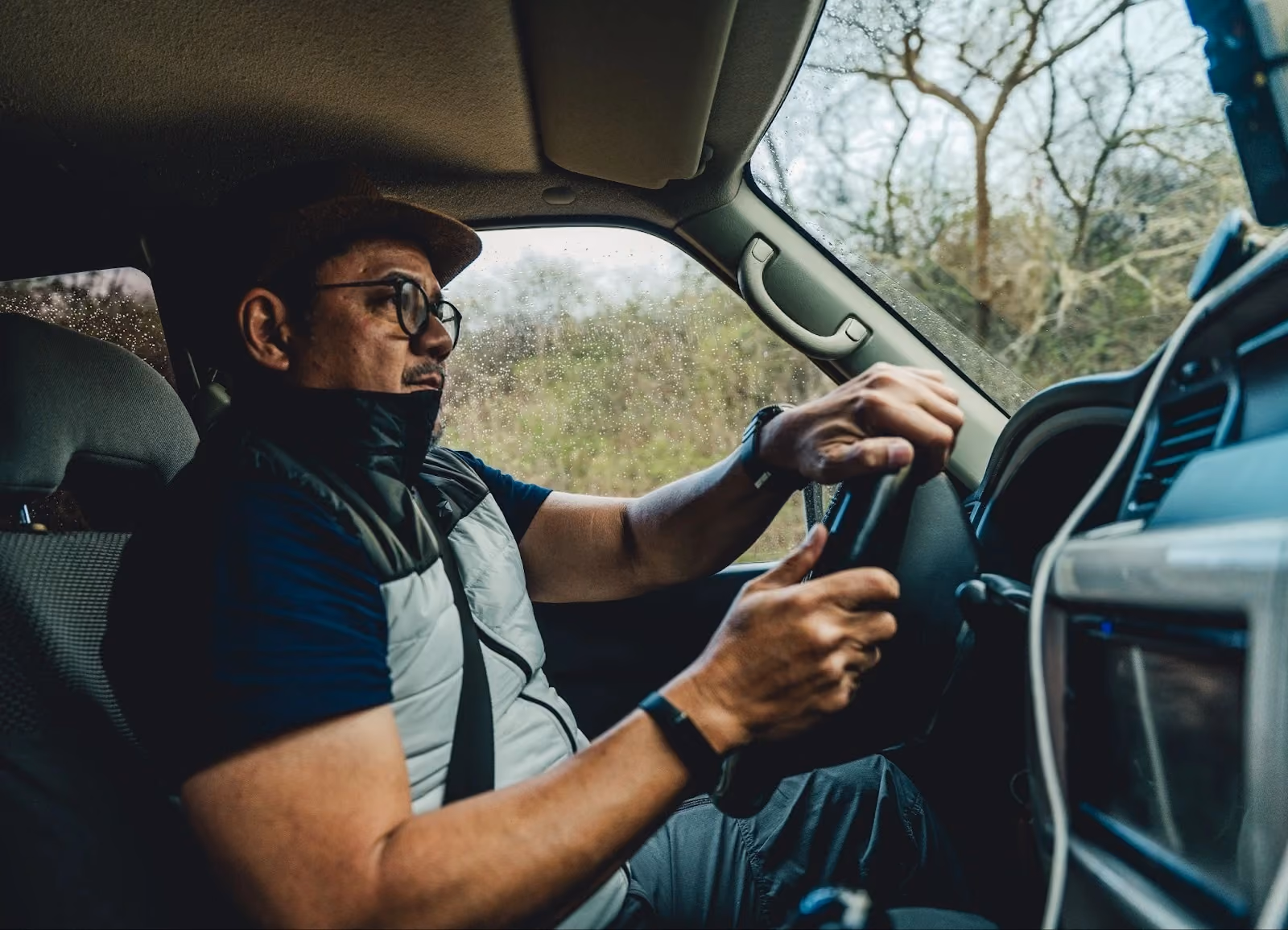 Traveller driving a 4WD vehicle in rainy conditions.