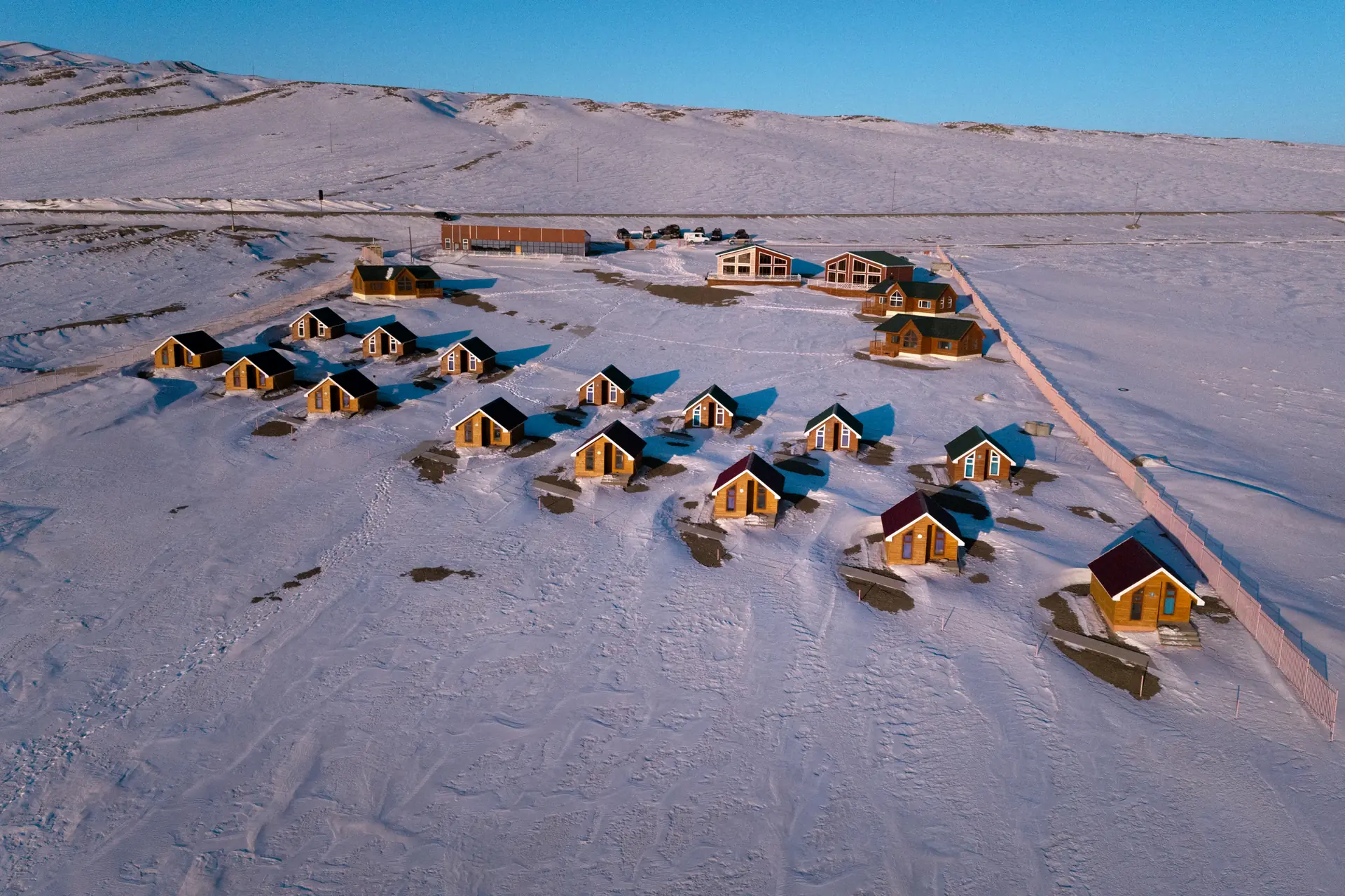 Aerial view of log cabins on the snowy shore of Khyargas Lake, Mongolia