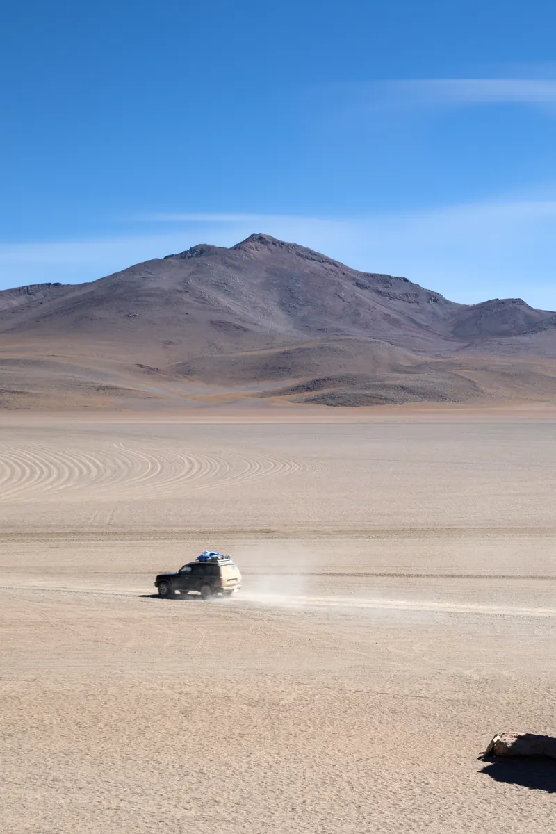 A 4x4 crossing the Siloli desert near the stone tree, Bolivia