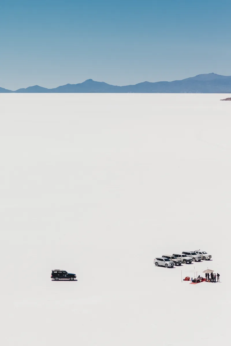 A convoy of 4x4s on the white Salar de Uyuni, Bolivia