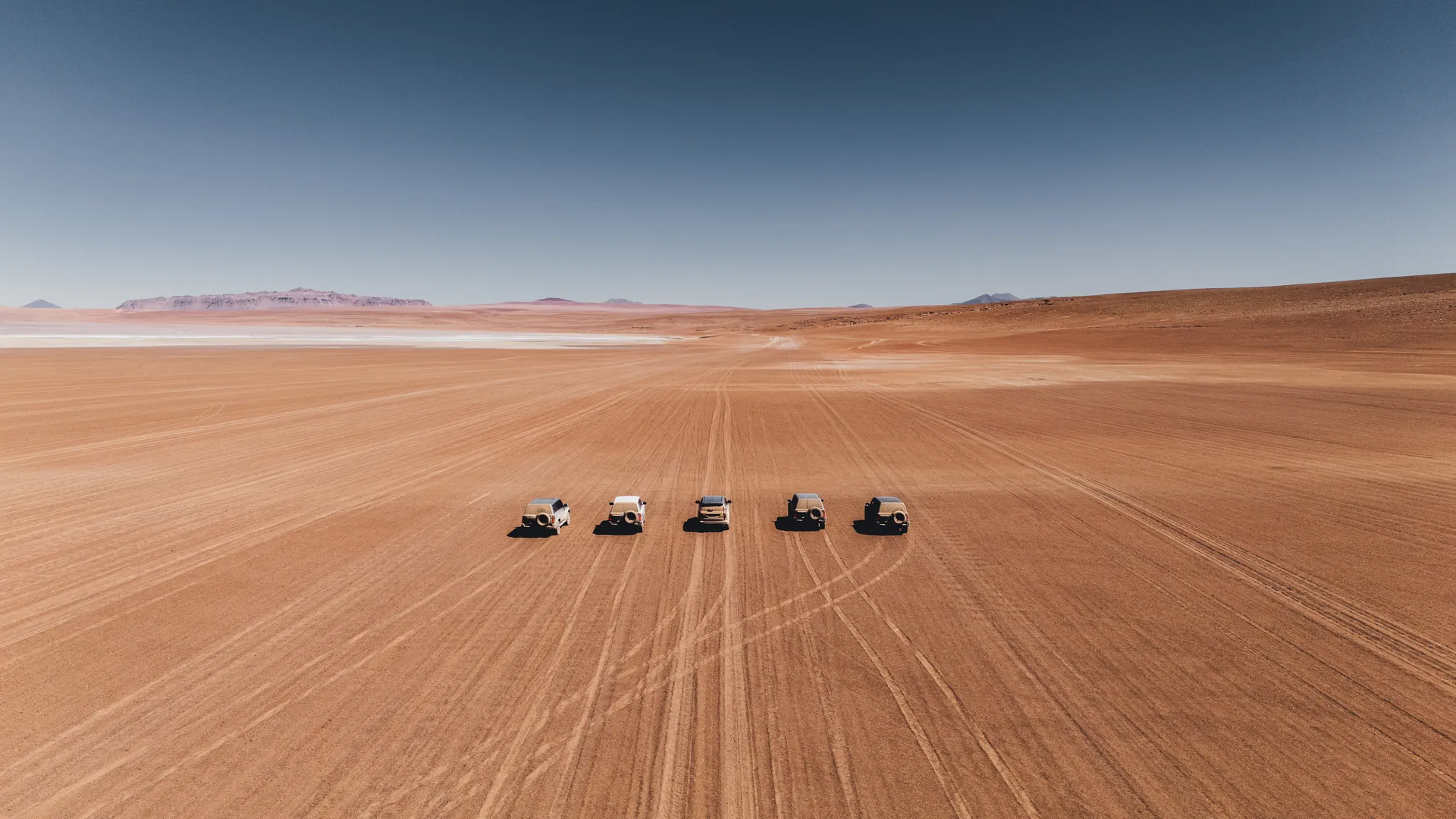 A convoy of five 4x4s on the high desert of the Bolivian Altiplano, Altiplano Run expedition