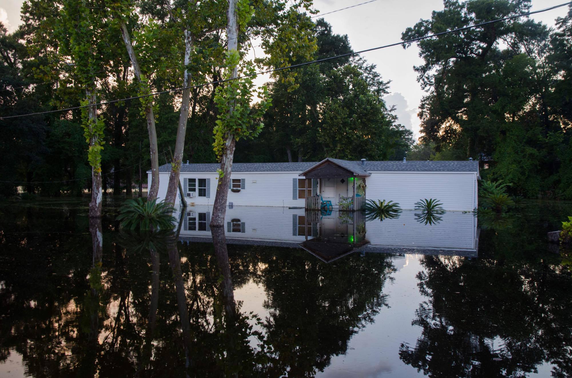 A small house surrounded by flood waters