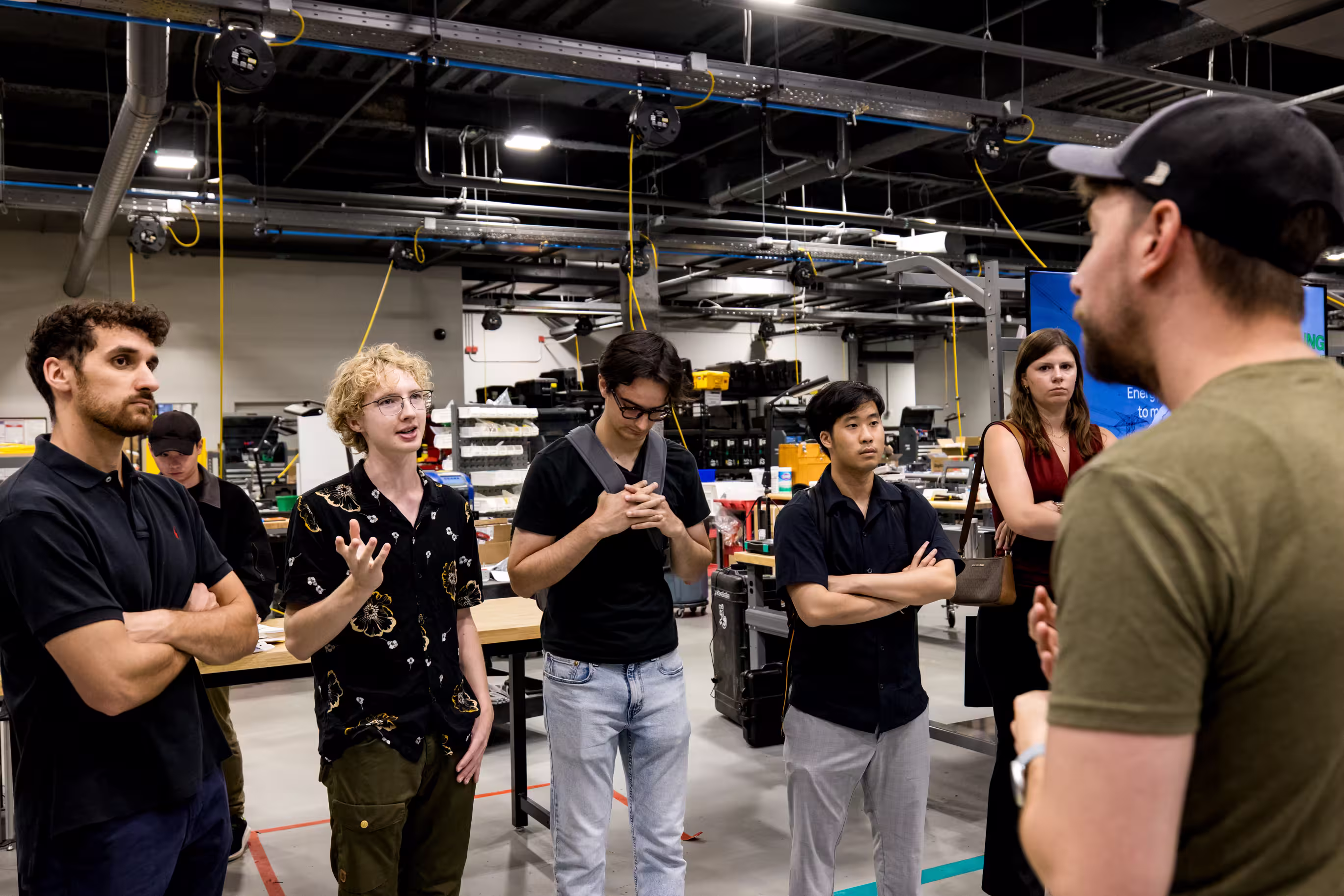 Summer mini modules DTI participants touring robotics manufacturing facility.