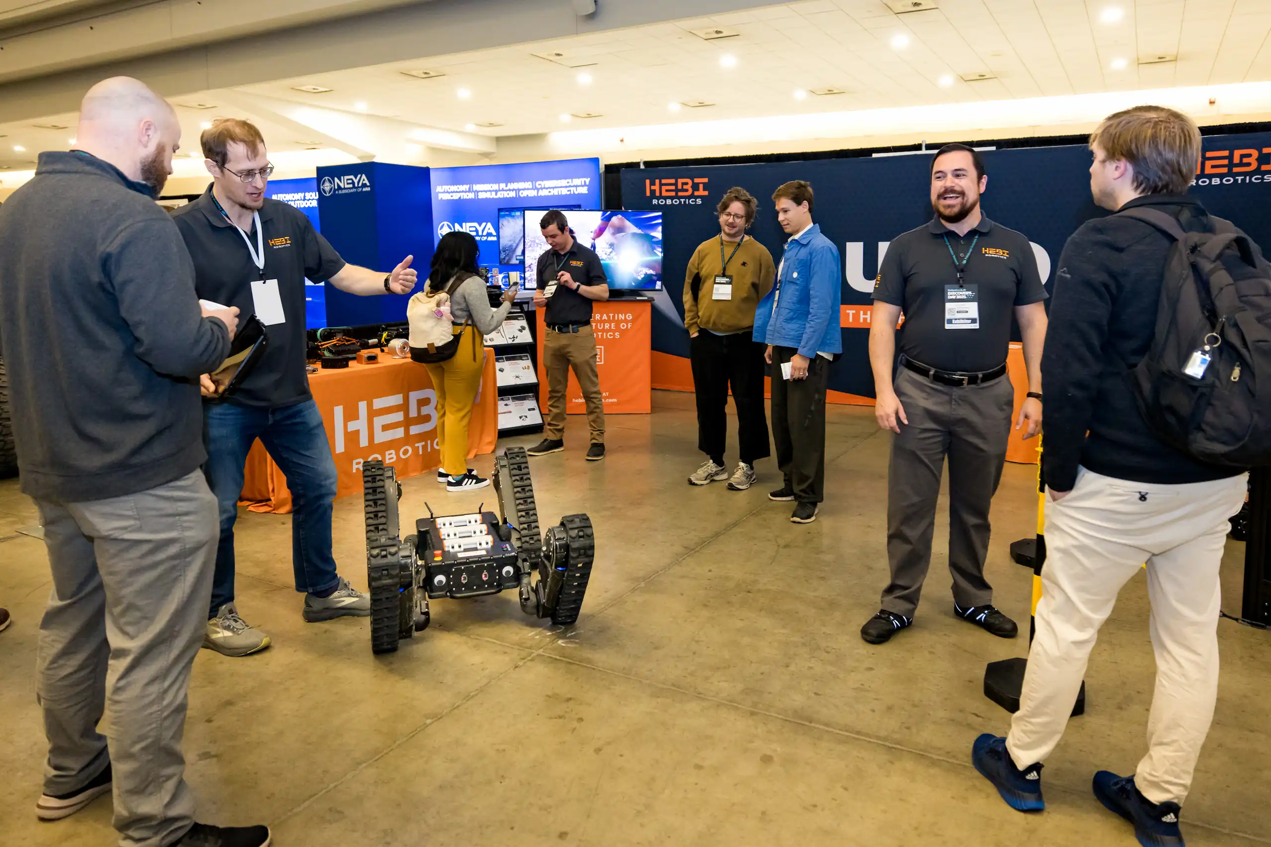 Group of attendees at Pittsburgh Robotics and AI Discovery Day learning about HEBI Robotics