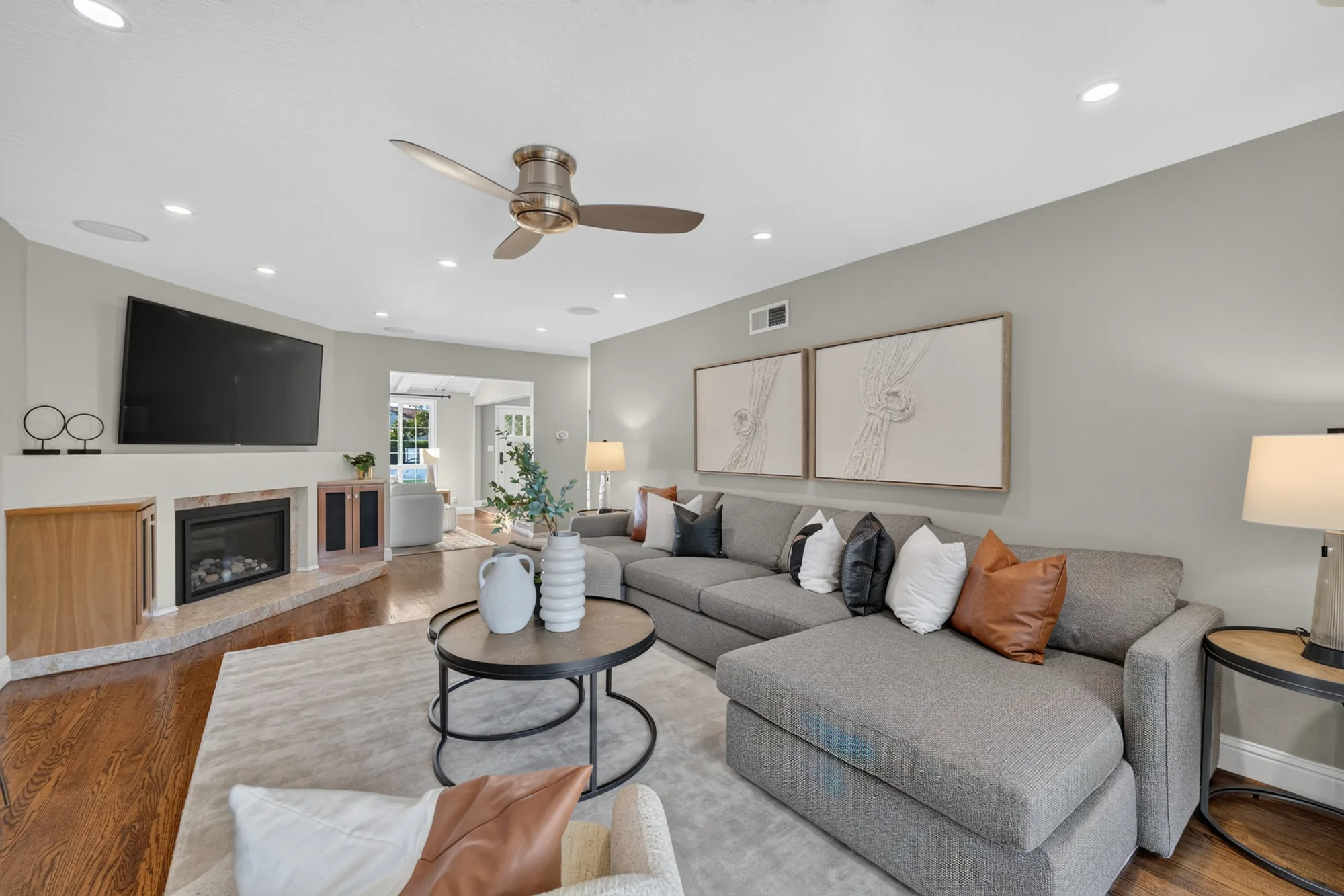 Family room with fireplace and sectional after staging