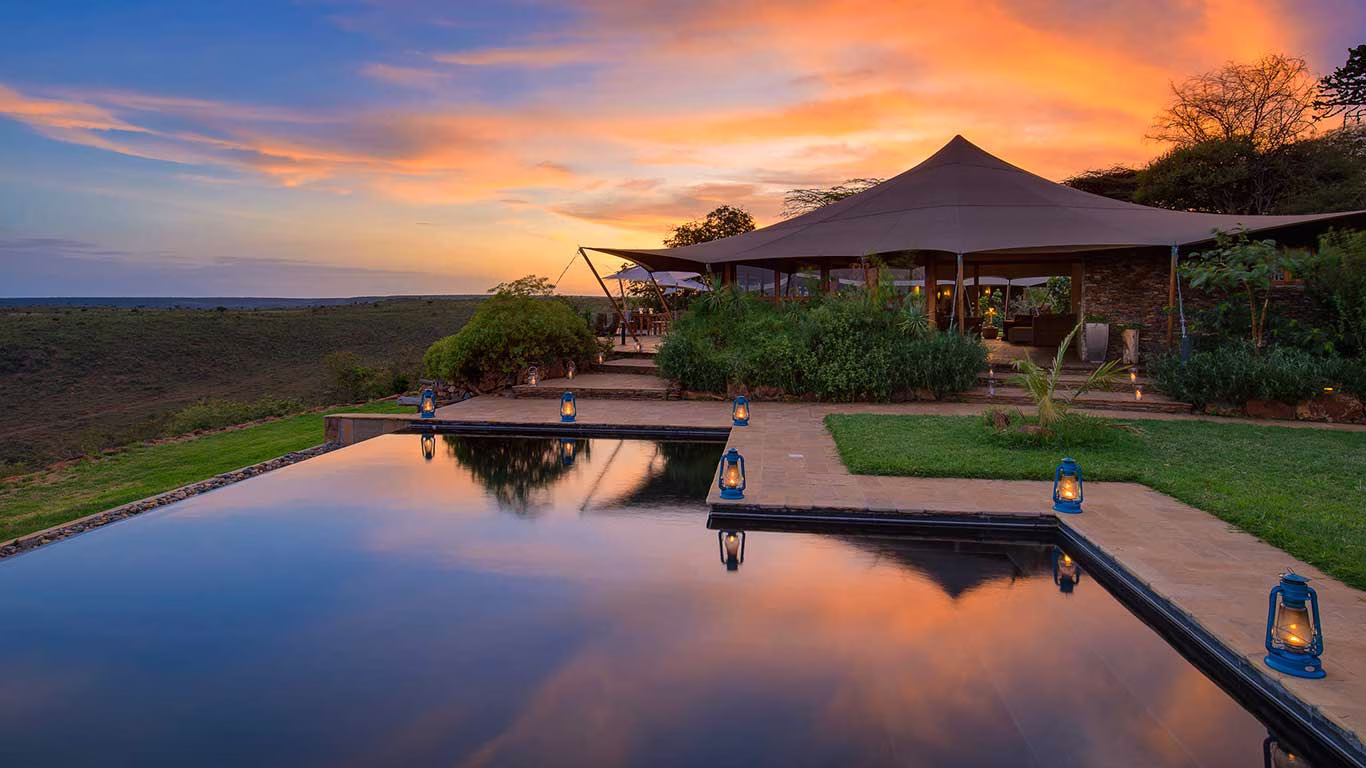 Lantern-lit serenity by the pool at sunset at Elewana Loisaba, Laikipia.