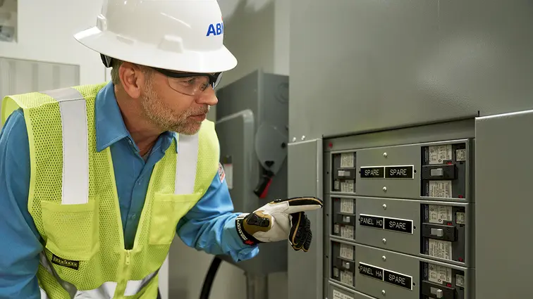 ABM engineer examining a facility’s electrical fuses. 