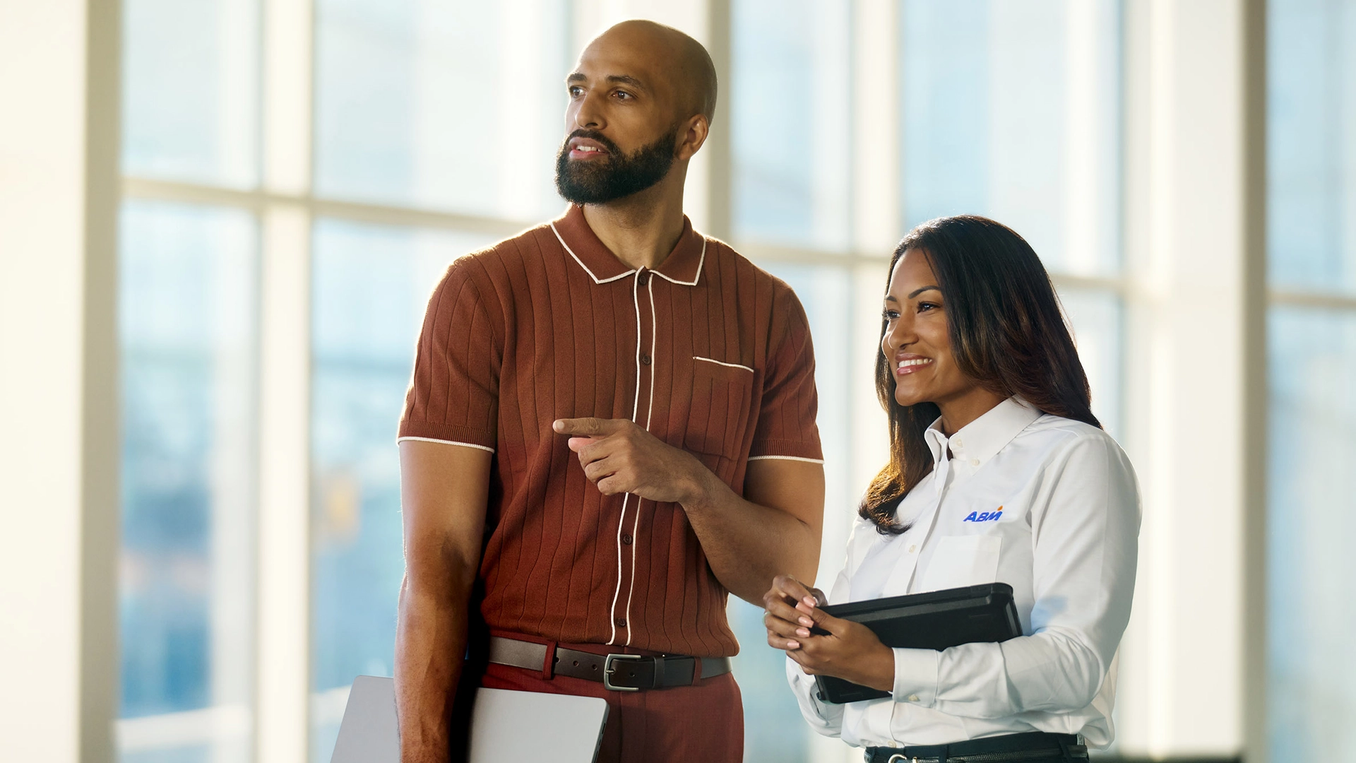 A man asking a woman in an ABM uniform a question