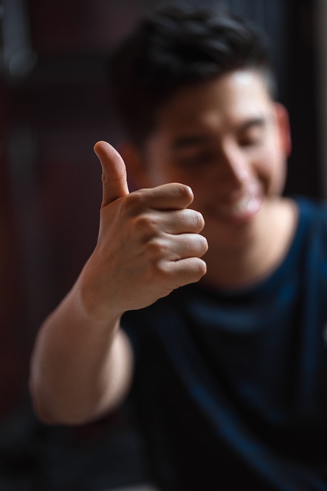 A satisfied customer gives a thumbs-up gesture
