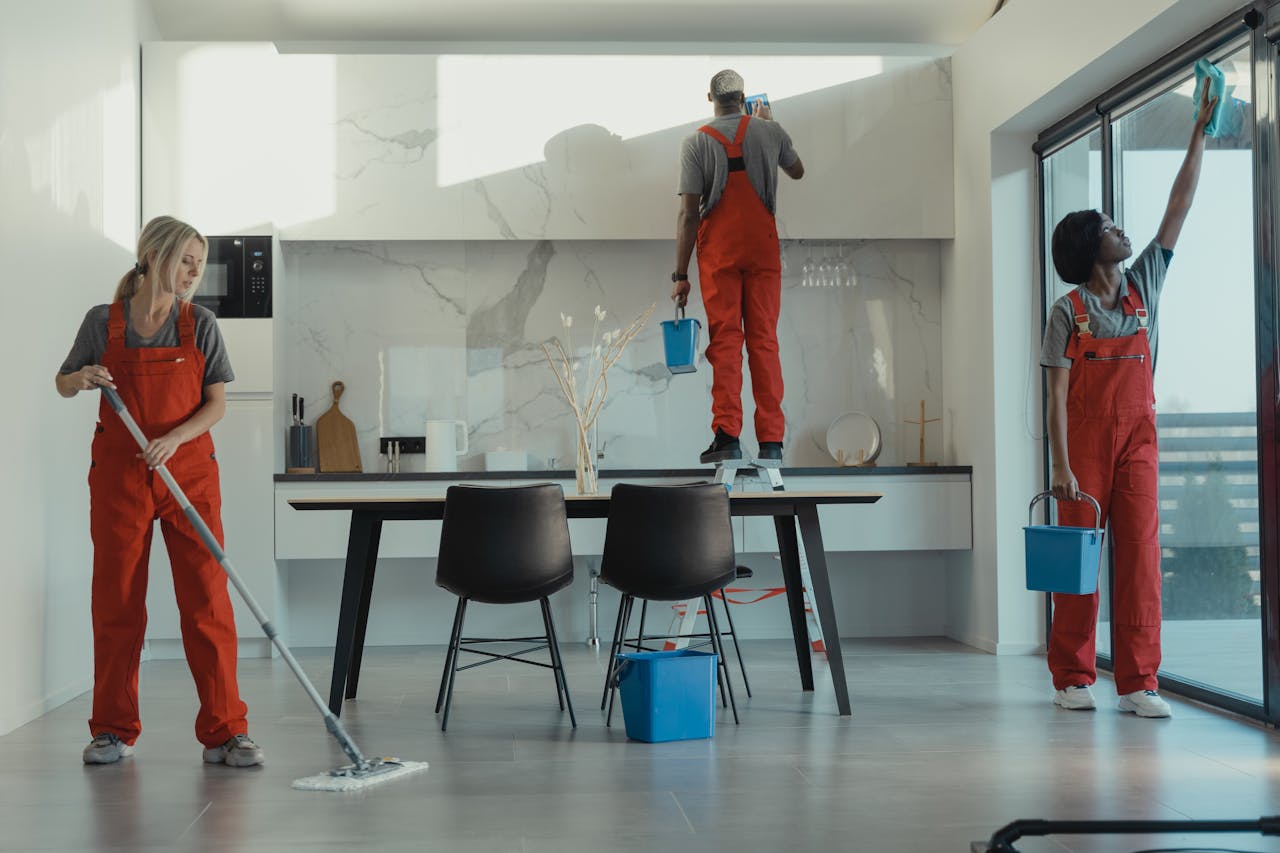 A team of cleaning professionals is working in an office.