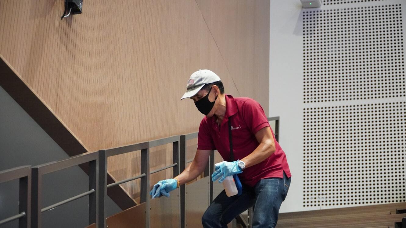A man cleaning handrails