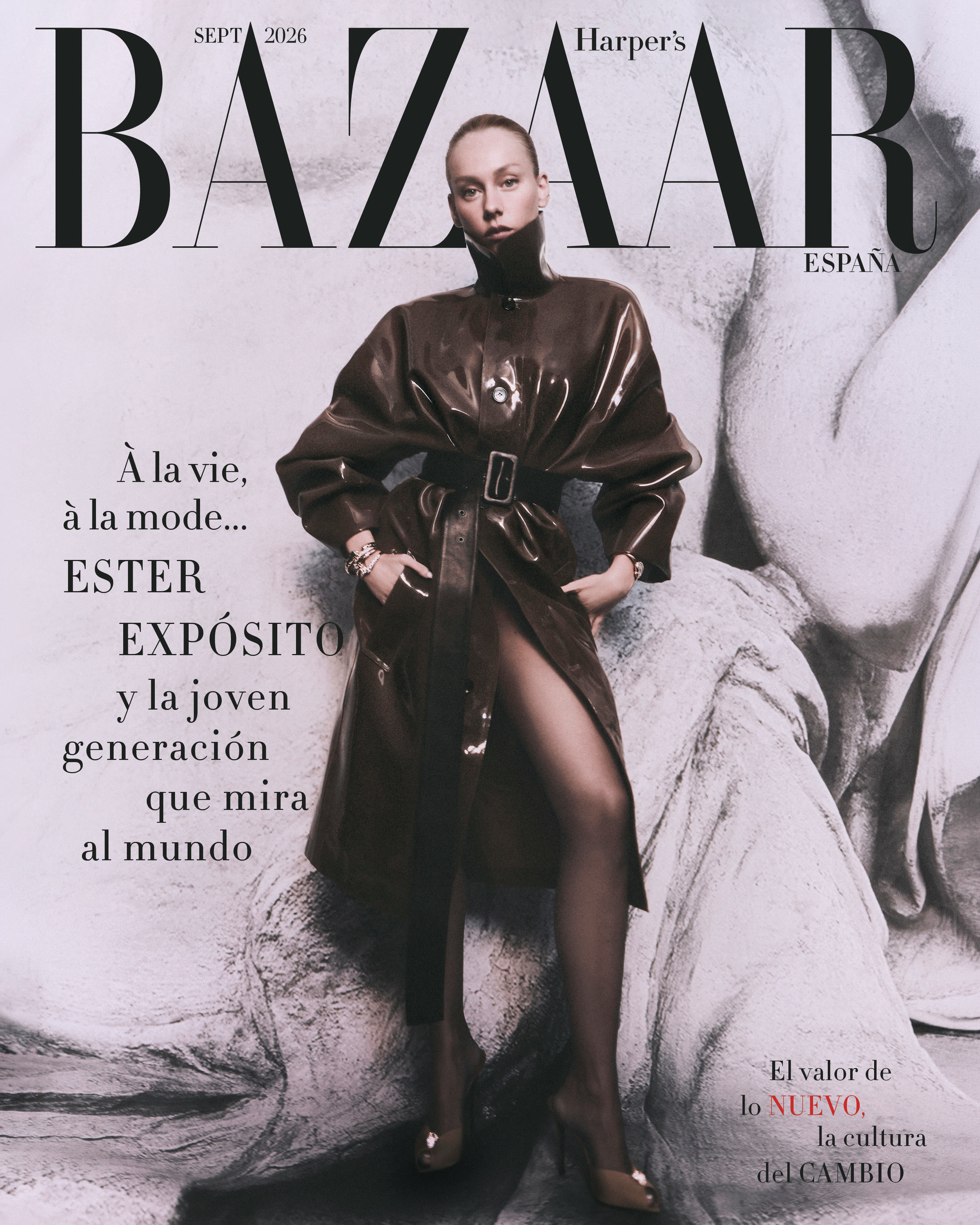 Ester Expósito in a belted dark glossy coat on an alternate September 2026 cover of Harper’s Bazaar España.