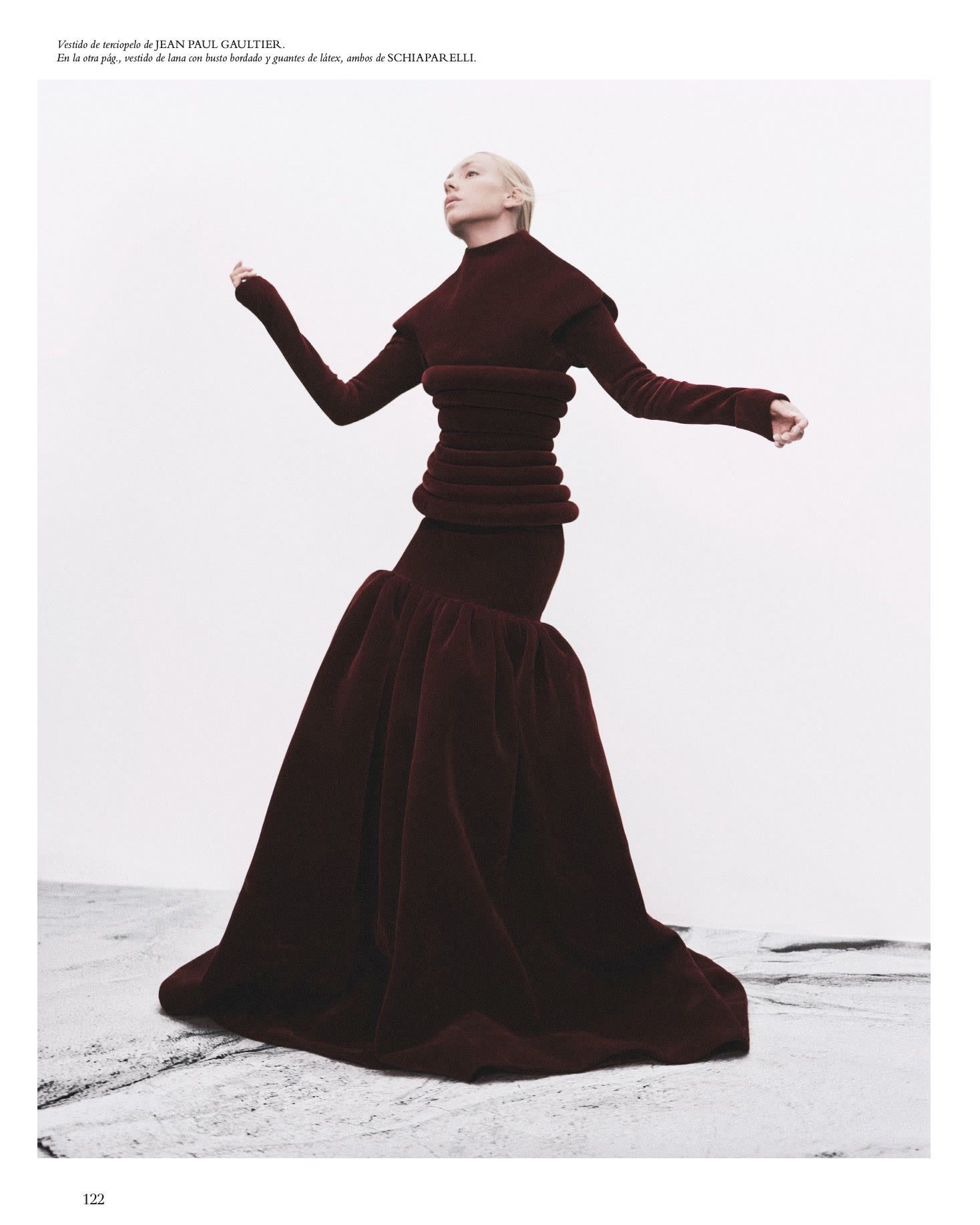 Magazine spread of Ester Expósito in a floor-length burgundy Jean Paul Gaultier dress with a sculptural padded waist for Harper’s Bazaar España.