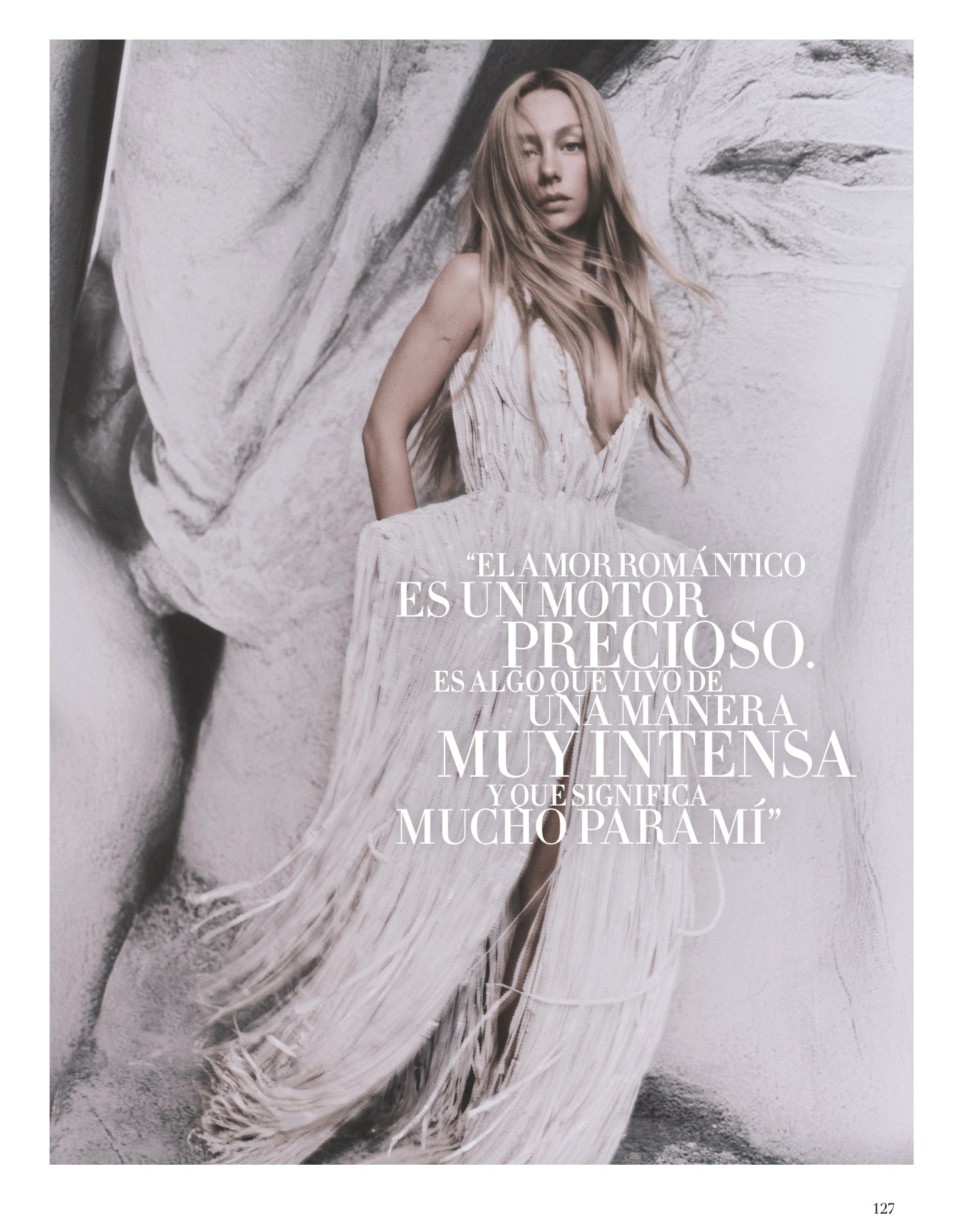Magazine spread of Ester Expósito in a white fringed Schiaparelli dress before abstract drapery, overlaid with a Spanish quotation.