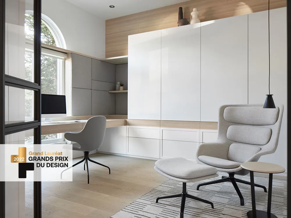Designer office with custom storage, a lounge chair, and a work area