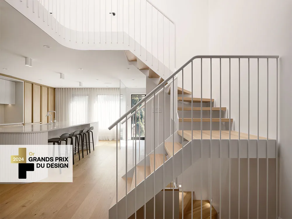 A white, sculptural staircase and an open-concept kitchen with wooden cabinets