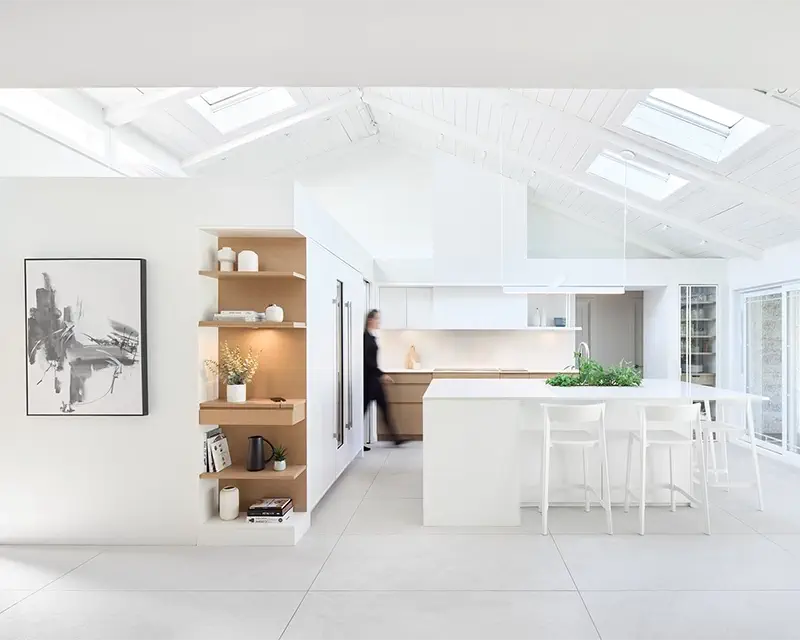 White kitchen with a cathedral ceiling and a central island