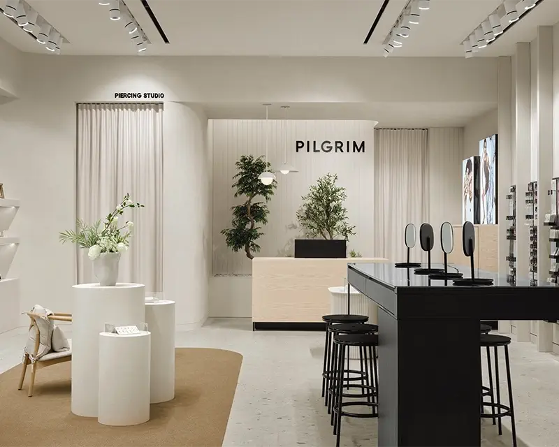Designer store with white display cases and a reception counter