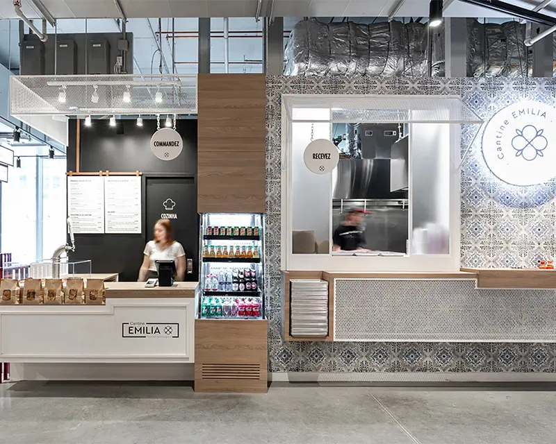 Food kiosk with a wall of blue azulejos tiles and a wooden counter