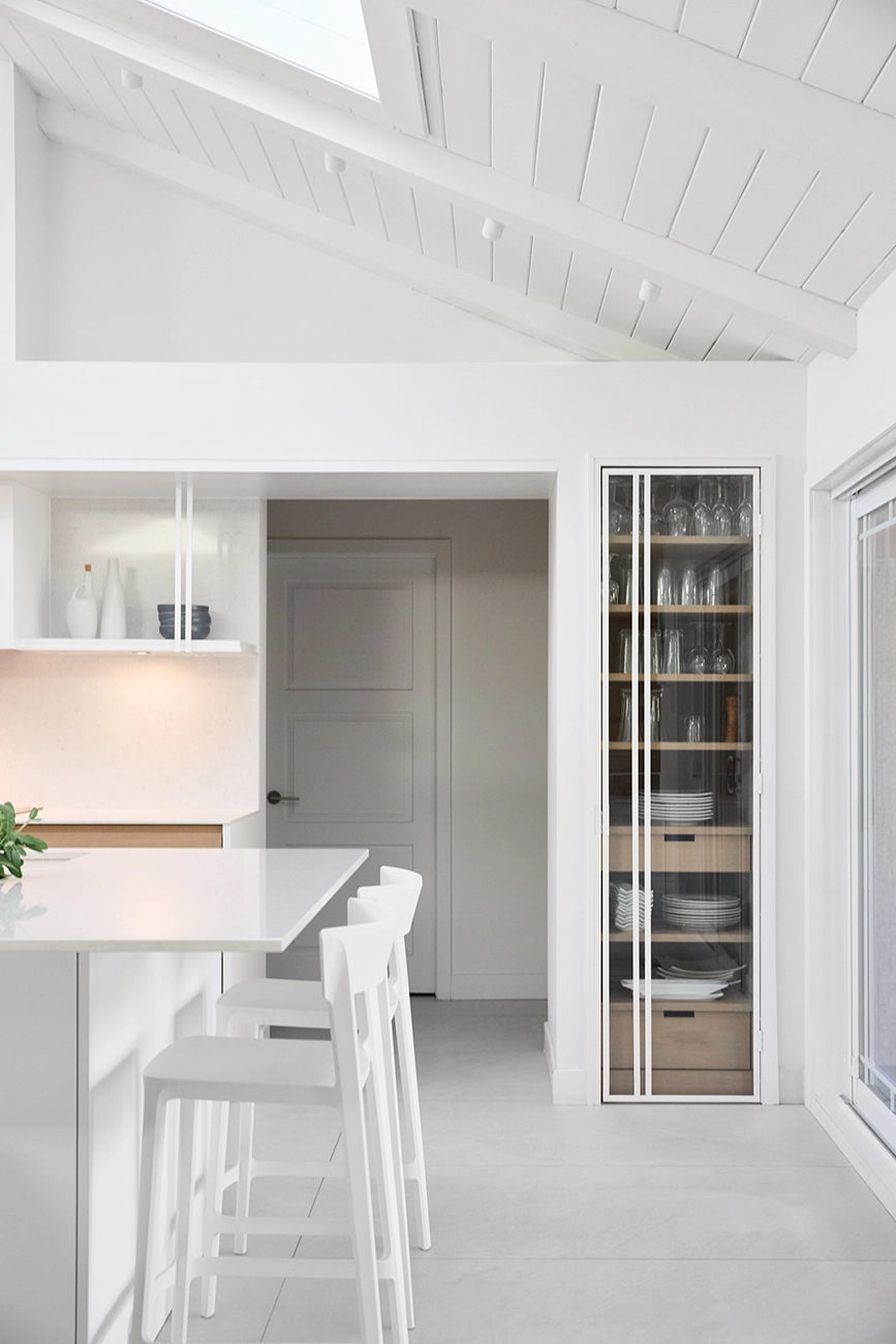 Dining area with a glass-fronted oak china cabinet and a door leading to the hallway