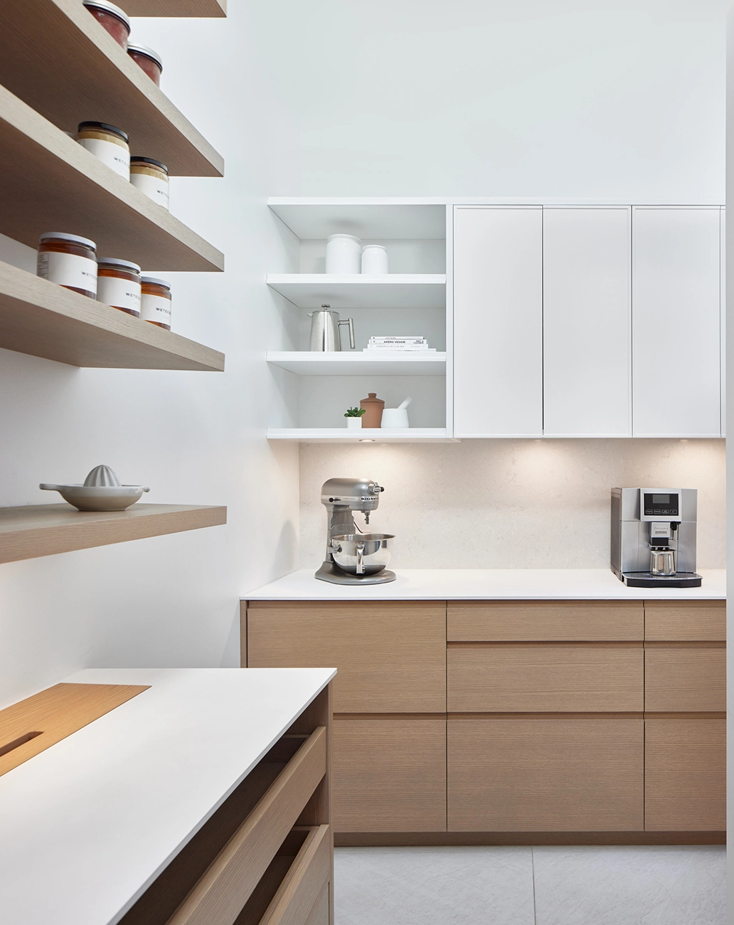 Kitchen with open oak shelving, a freestanding range, and a built-in coffee maker