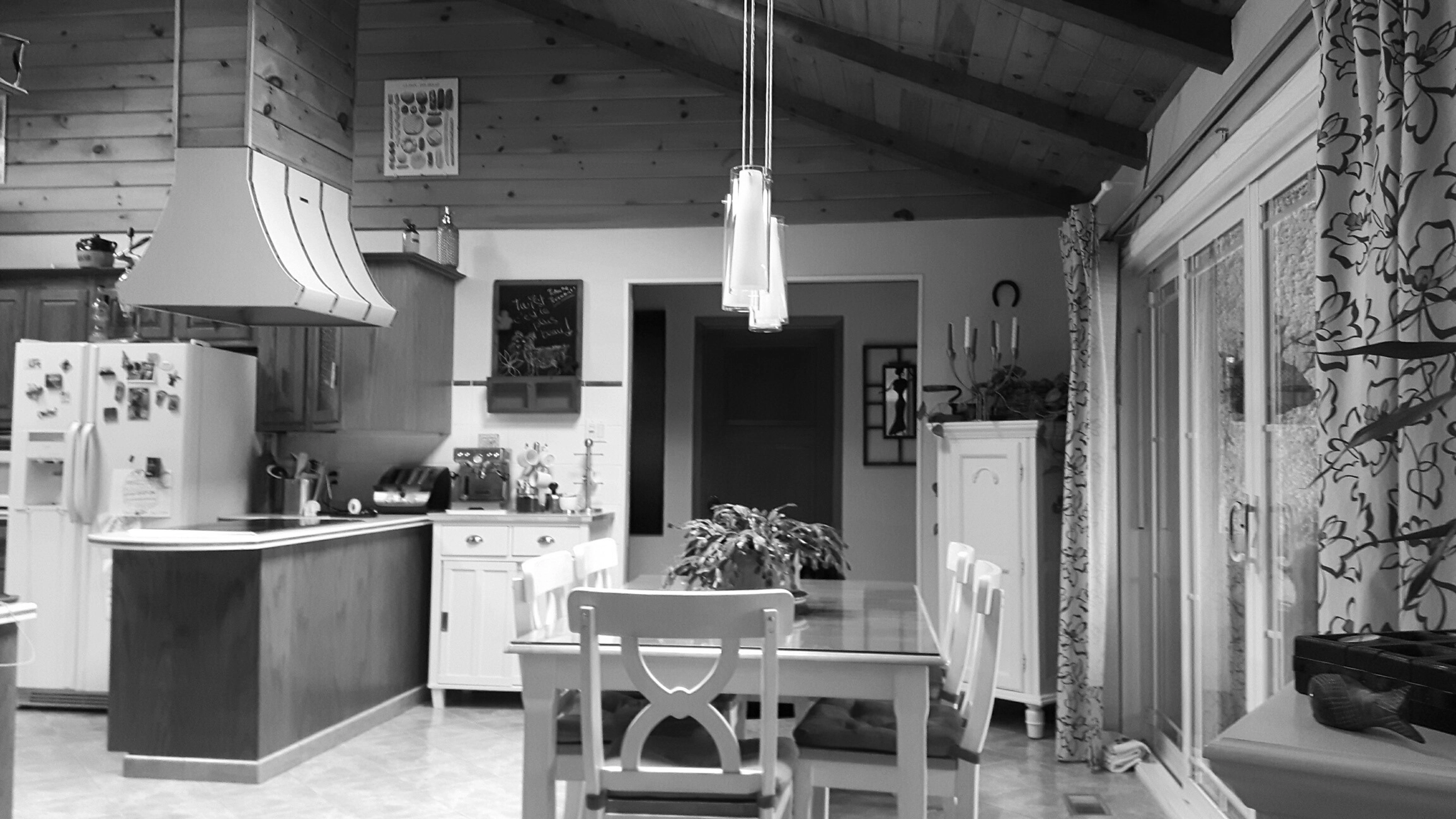 The old kitchen and dining room with dark wood finishes before the renovation