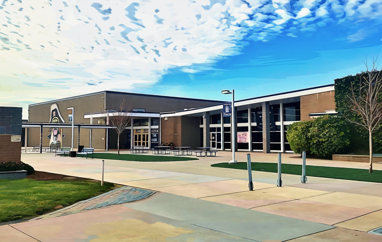 a school building set against a dramatic sky full of clouds.