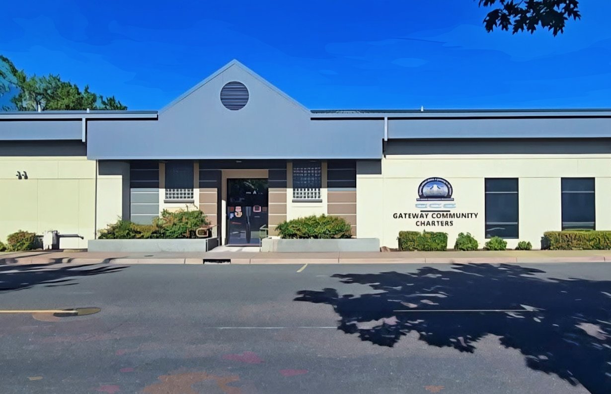 a single-story building photographed against a bright blue sky.