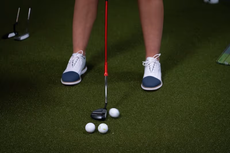 Golf student hitting a golf ball during a golf lesson