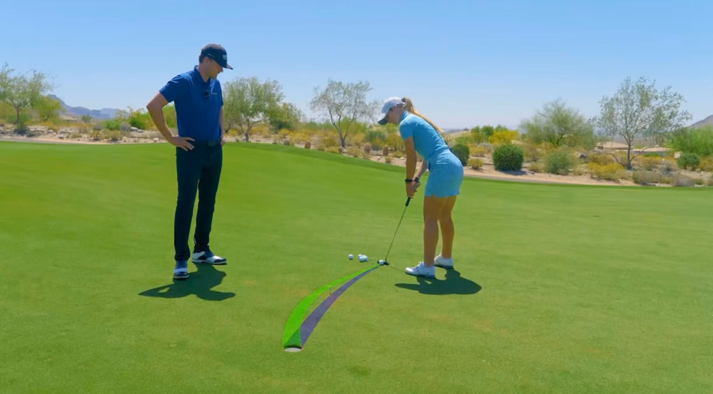 Fredrik Lindblom working with student on getting better at putting.