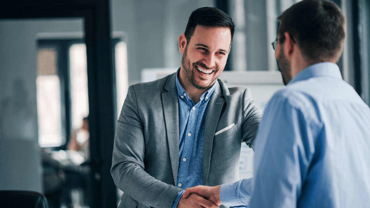 One employee shaking a manager's hand