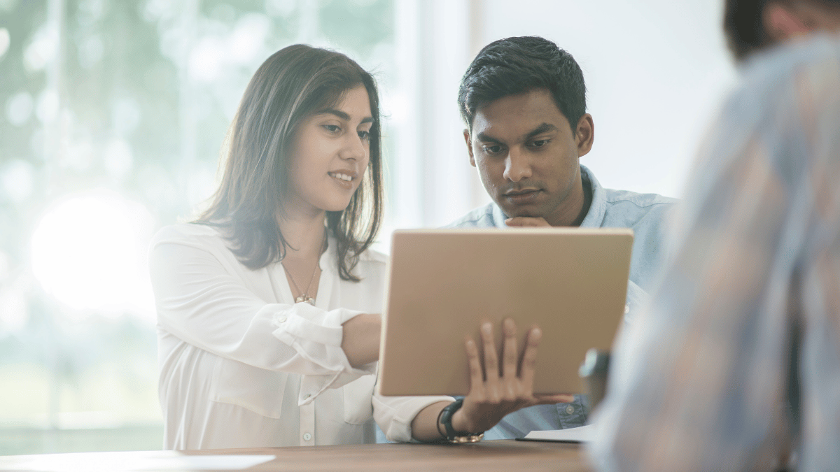 two employees reviewing notes on tablet.png
