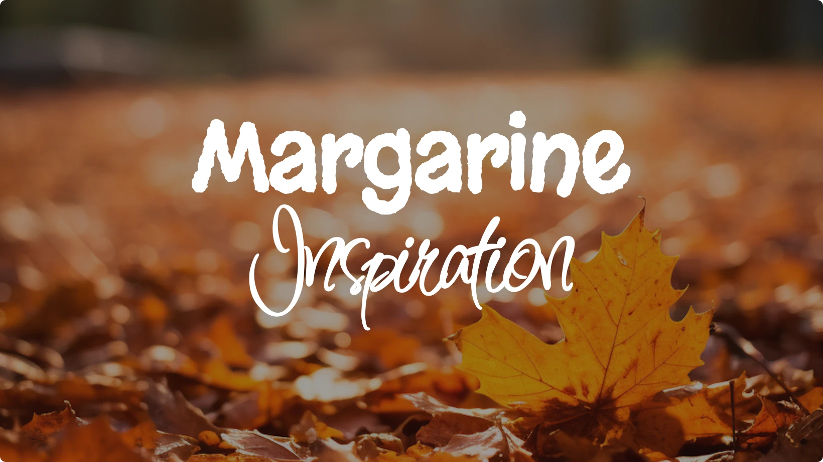 Example of font pairing using Margarine and Inspiration displayed over a background of autumn leaves, showing the contrast between a bold, playful typeface and an elegant, flowing script.