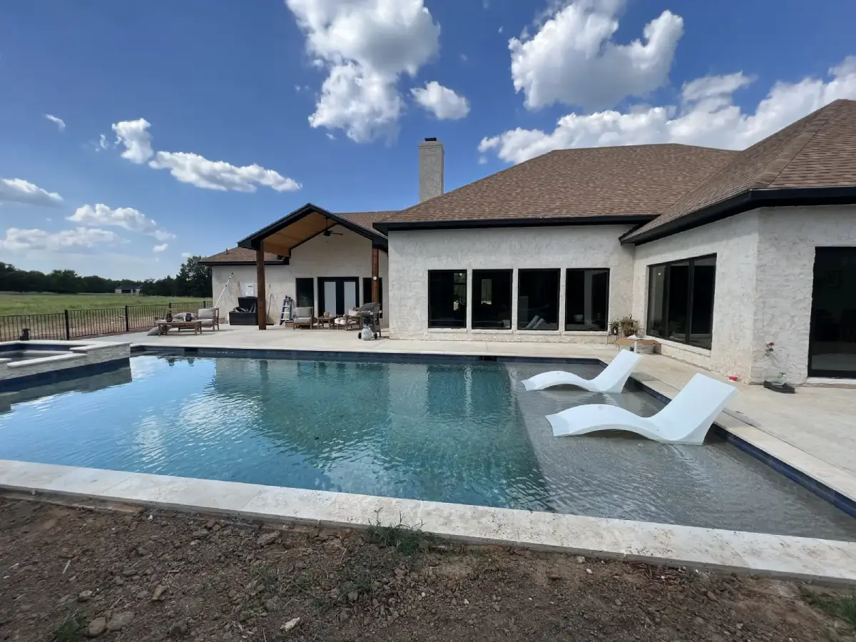 A house with a nice pool with a roof installed by Roofit Roofing & Construction.