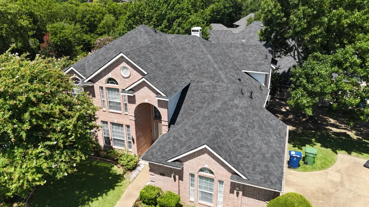 A residential home with a new roof installed by Roofit Roofing & Construction.