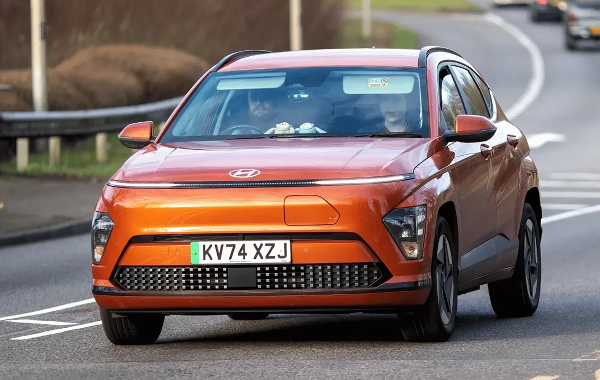 Orange Hyundai Kona EV driving in Milton Keynes, UK