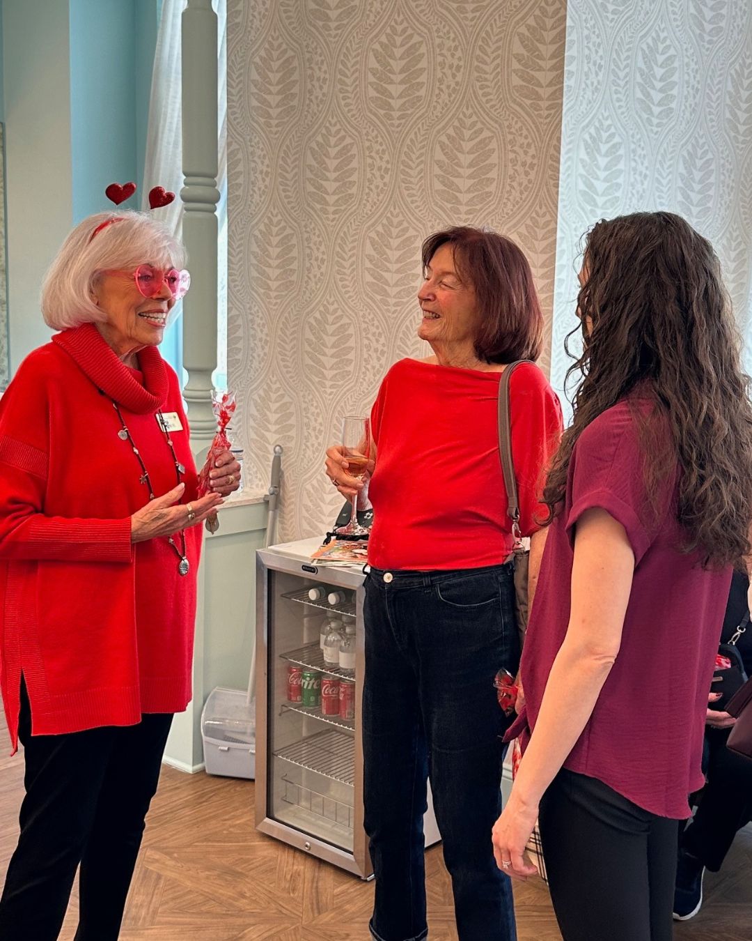 Three women enjoy a Galentine's Day celebration at Symphony Park senior living.