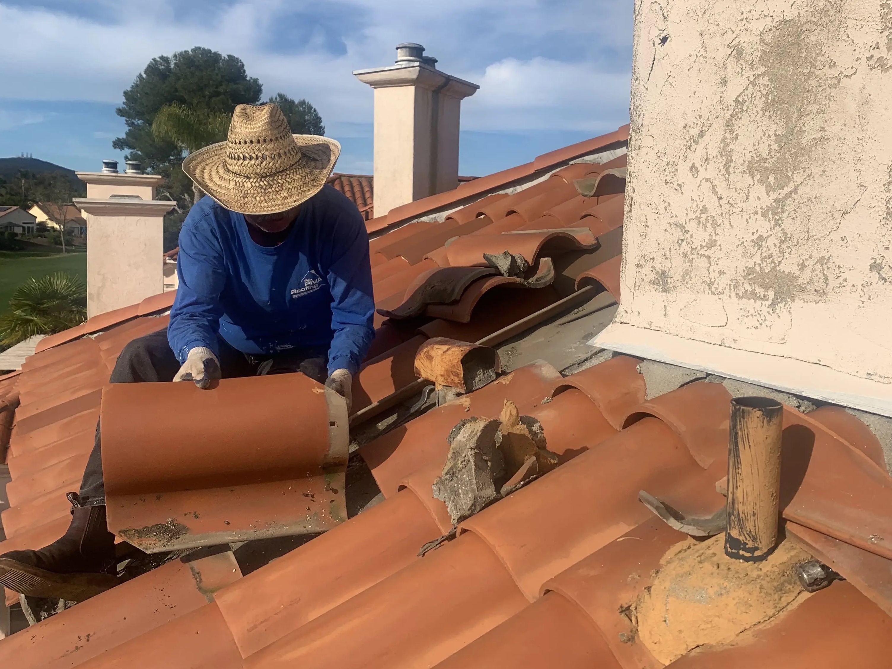 Roof Repair, Close up of roofer installing ceramic tiles.