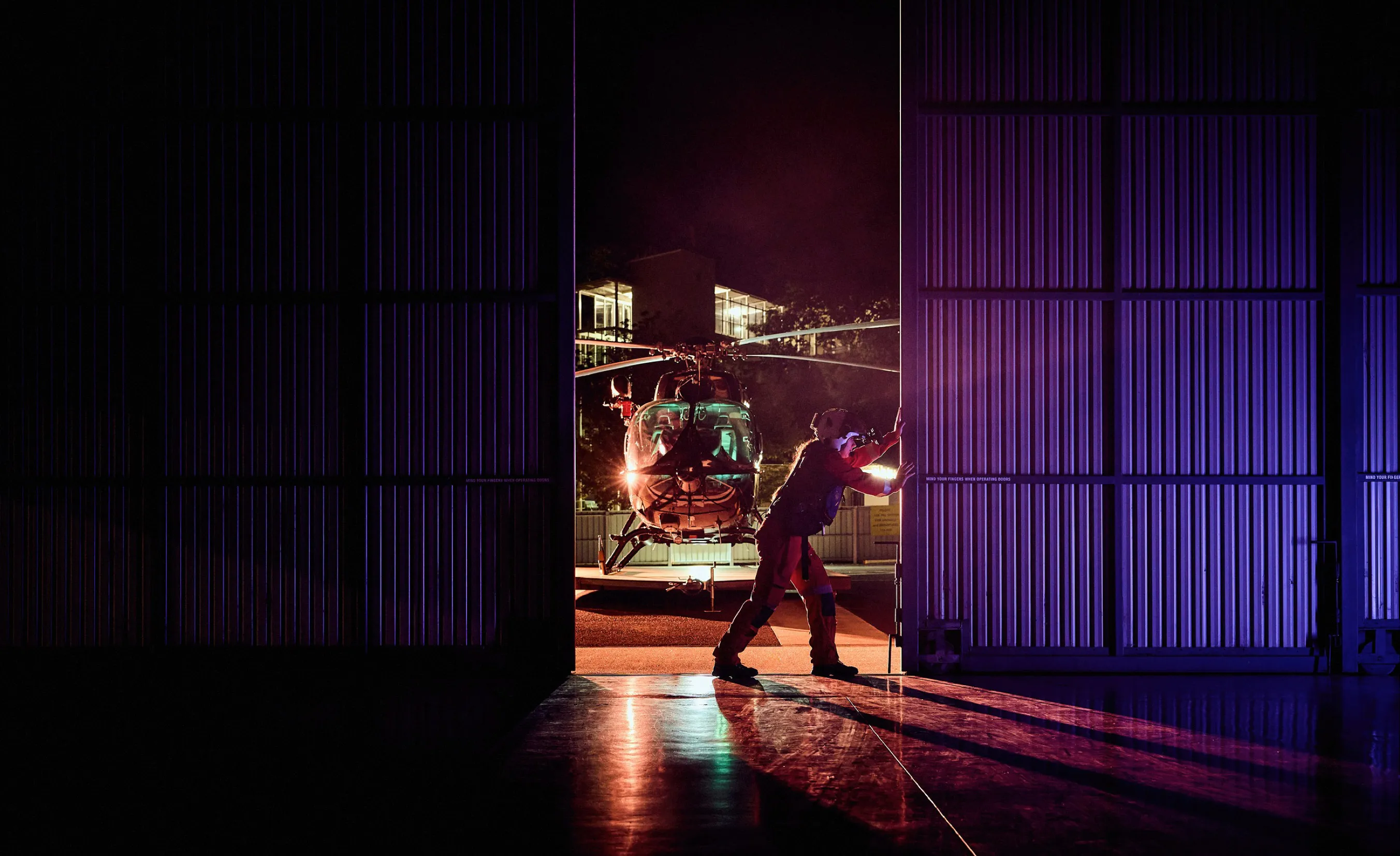 Female rescue helicopter pilot opening the hander doors