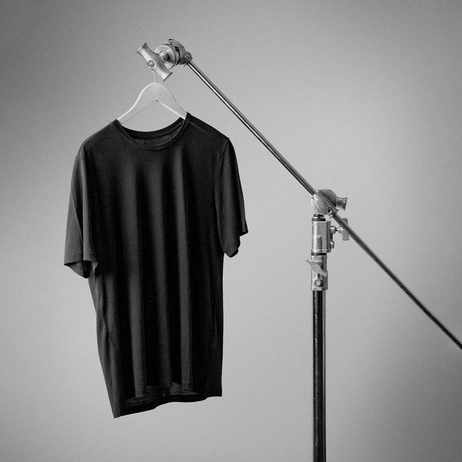 a black t-shirt hanging off a lightning stand