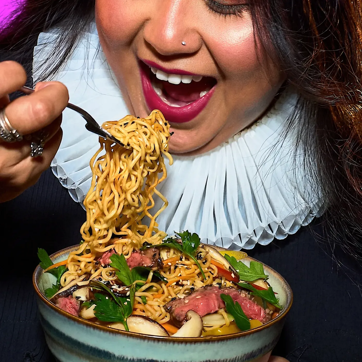Woman eating a noodle dish