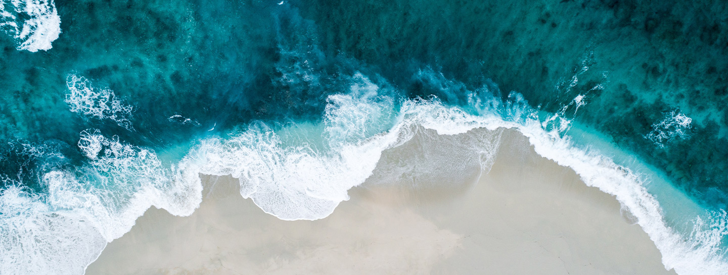 blue ocean with white sands