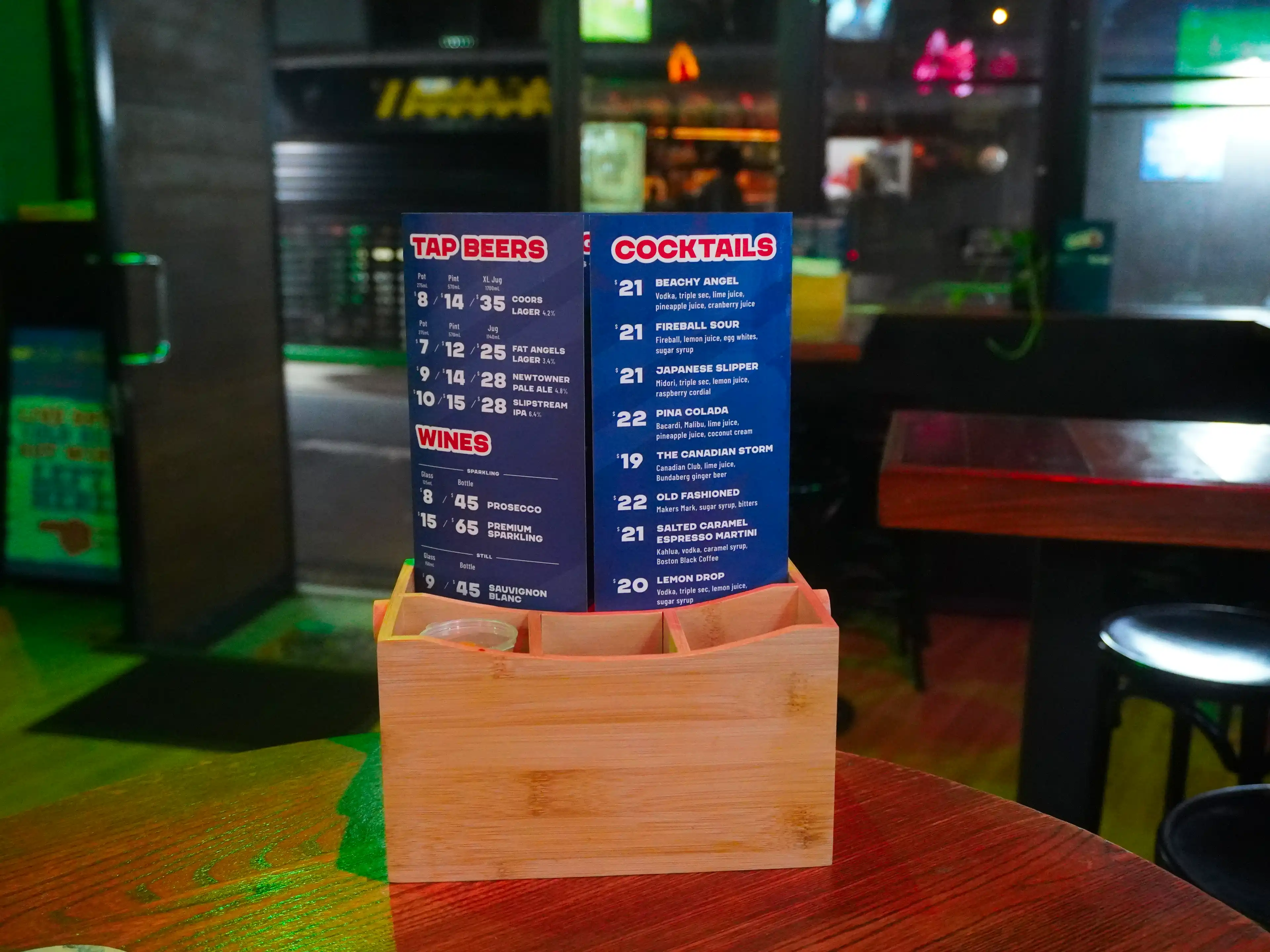 A photo of the Fat Angel Sports Bar and Grill menu in a table holder.