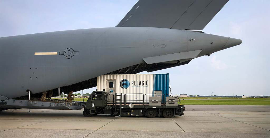 Pelagic Research Services Mobile Command Center being loaded onto a cargo plane