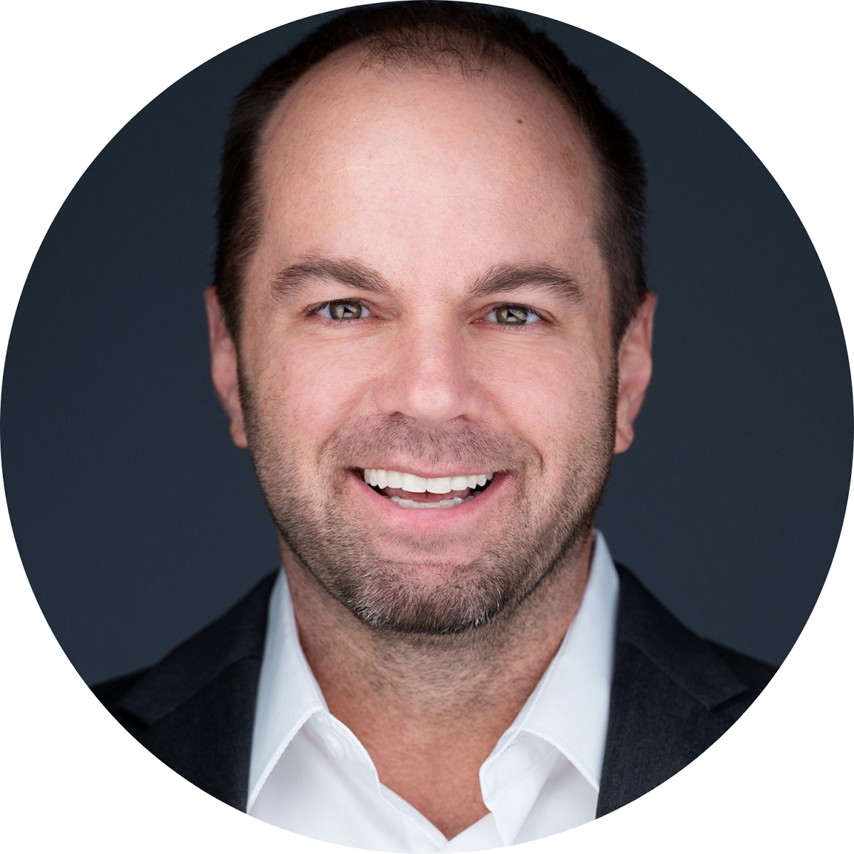Professional headshot of American entrepreneur Nick Berry on a round dark background.